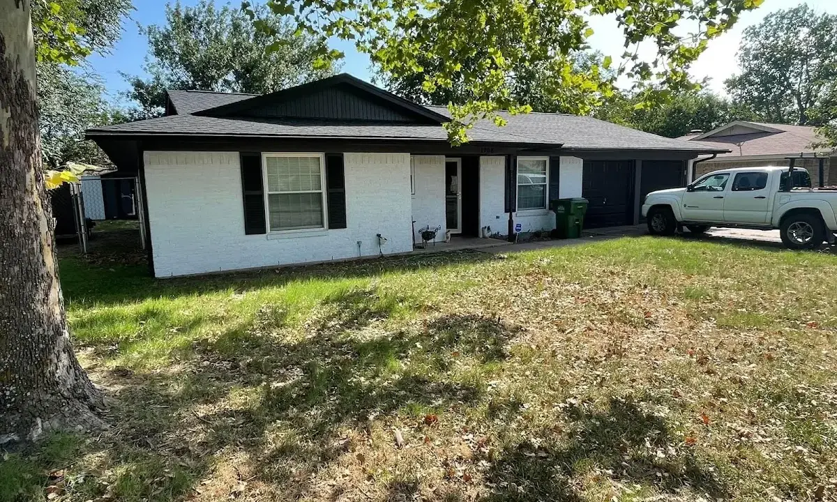 Professional roofing crew working on a residential roof in Monticello